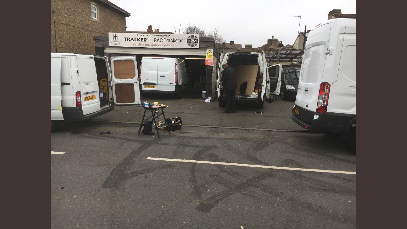 Rear view of the workshop area at the Welling premises, various security precaution jobs being carried out for van drivers