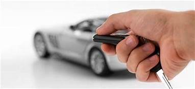 Close up view of a hand arming a car with an example of one of our remote alarms, typical to example of an aftermarket system