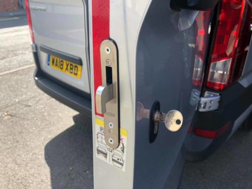 Close up of the side view of a van door showing a well installed locks$vans lock with key